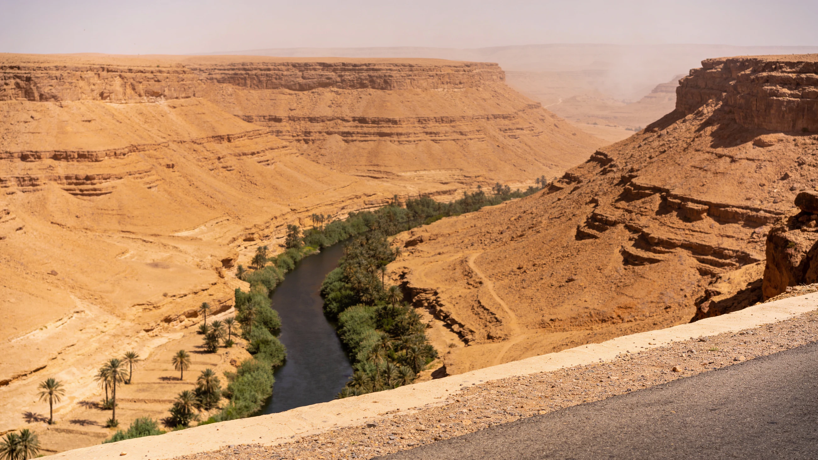 Synthetic editorial study of scarce water organizing a dry Moroccan landscape.